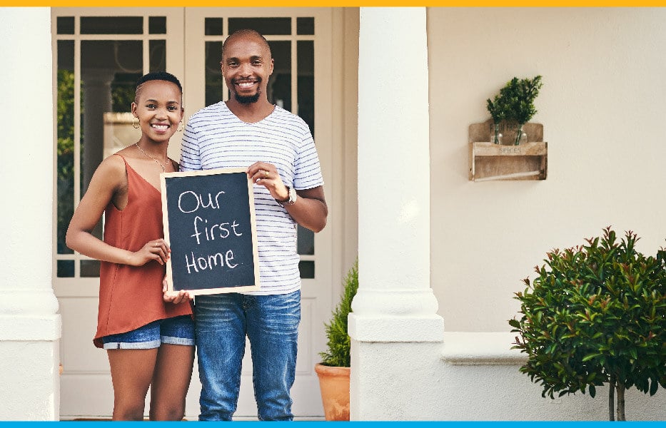 Black first time homebuyer couple standing outside their new home Black first time homebuyer couple standing outside their new home