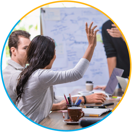 Man and woman in business meeting with the woman raising her hand
