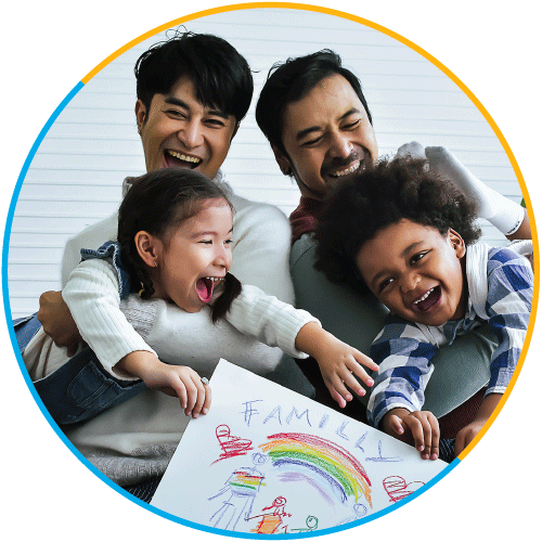 Two asian men with their children, laughing and holding a children's drawing of their family